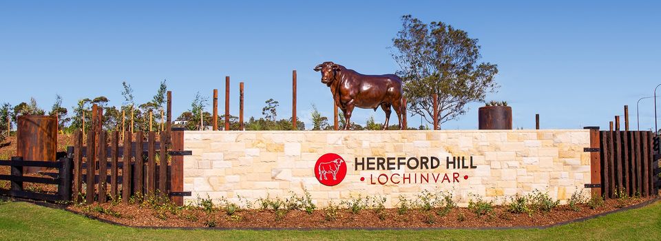 Bronze bull statue on stone Hereford Hill, Lochinvar structure.