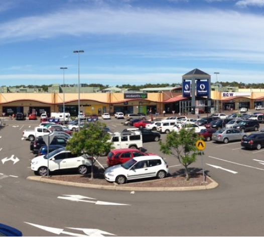 mall, shops, cars in a parking lot in Greenhills